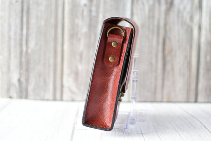 Red leather purse with a antique brass clasp on a white background